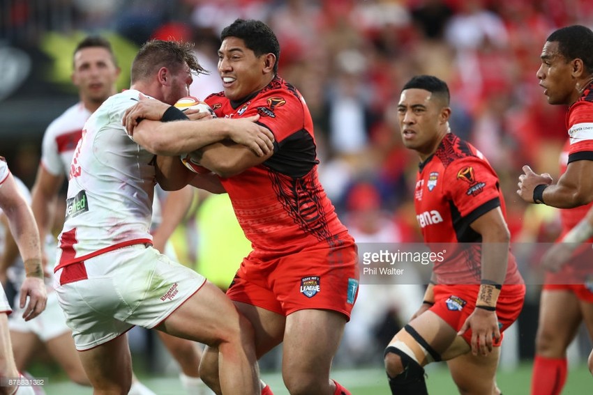 Jason Taumalolo is tackled by an english player