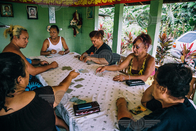 Tania To'omalatai (2nd right) playing card games with friends