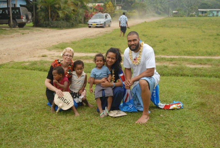 Iki with co-founder Patrick Osborne, Dr Angii Lever and local children