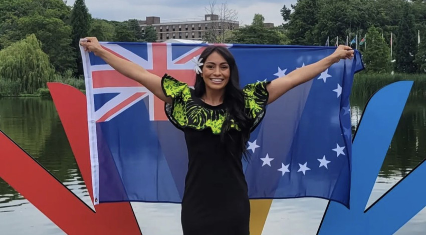 Kirsten proudly holding the Cook Islands flag in Birmingham