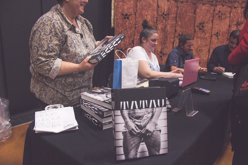 Signing books at the book launch and seminar at Auckland University