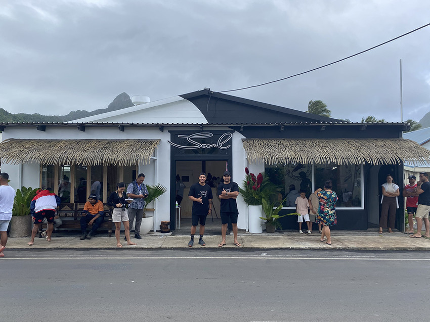 Vou (left) and Caleb (right) outside Soul - Cafe on the left and Barber shop on the right