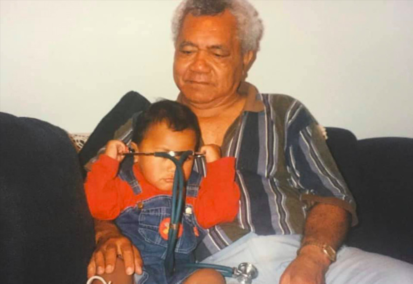 Sarah Elisaia with her grandfather as she holds a stethoscope years before she becomes a nurse.