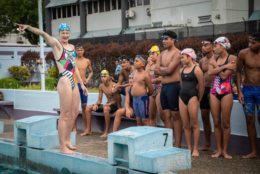 Fijian children listen to Australian Olympian Cate Campbell