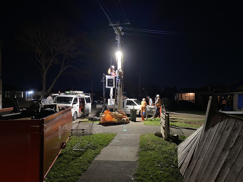 Power line workers work late into the night getting power up to residences in Papatoetoe