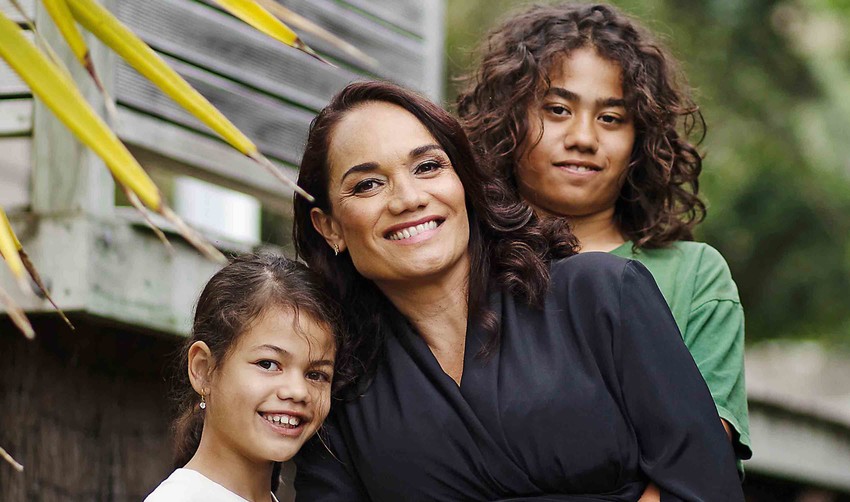 Tiana pictured with children, Karaunuhia (left) & Umuariki, whilst carrying Ngarangikahiwa. Photo: Woman / Zara Staples