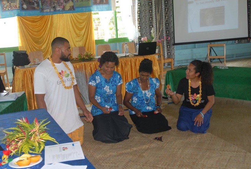 Super 15 Rugby player Patrick Osborne with Ikitaga and some local child educators