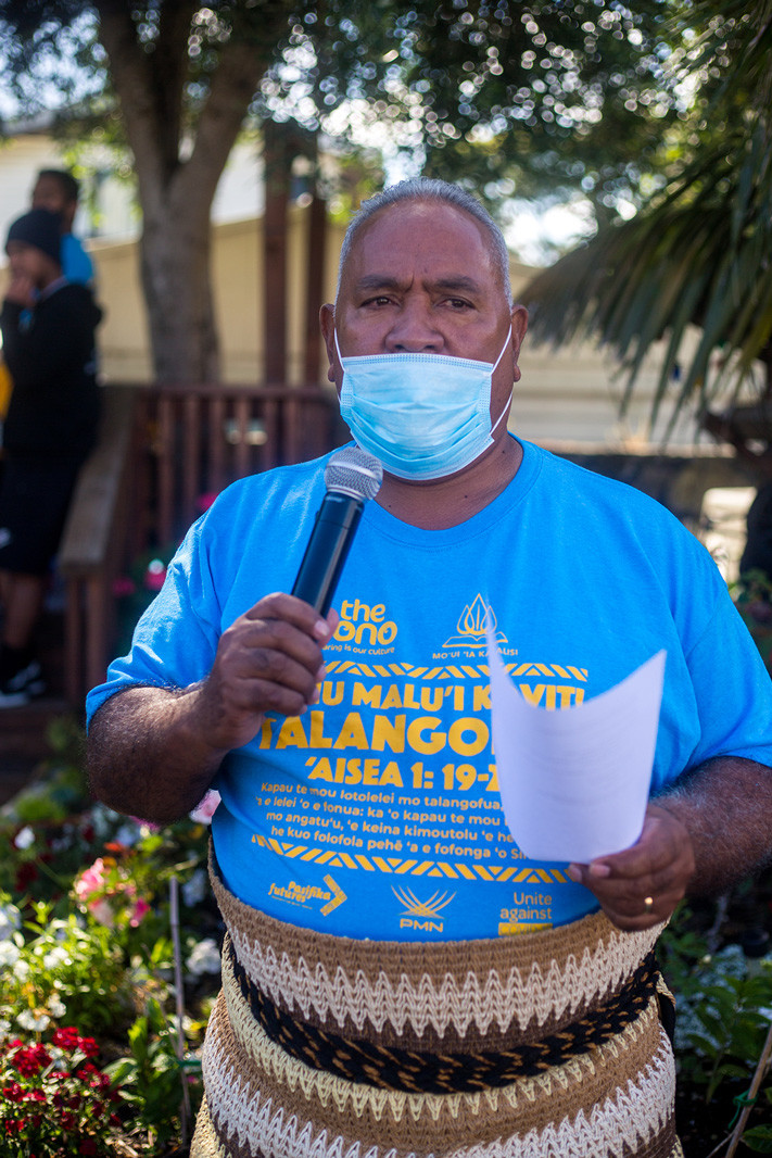 A church leader wearing the t.shirt with the scripture ‘Aisea 1: 19-20’ and the word ‘Talangofua’