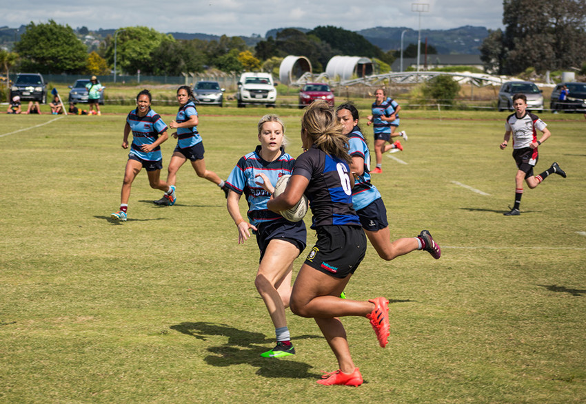 A Ponsonby player fends off a Rotoiti defender