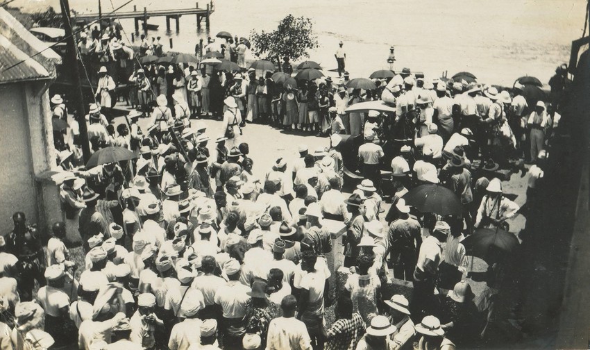 The men begin to move out of the lane to hop on lorries for their journey.