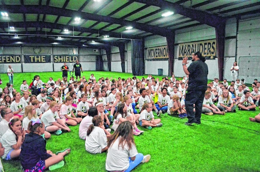 Junior Aumavae speaks to Mt. Vernon elementary school students during a workout and mentoring session.