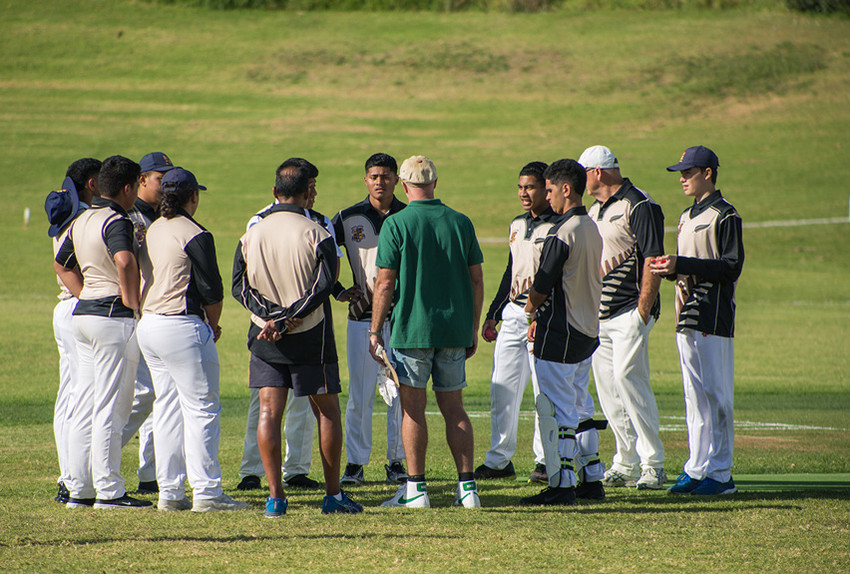 Coach Dion Nash has a word to the team before they take the field