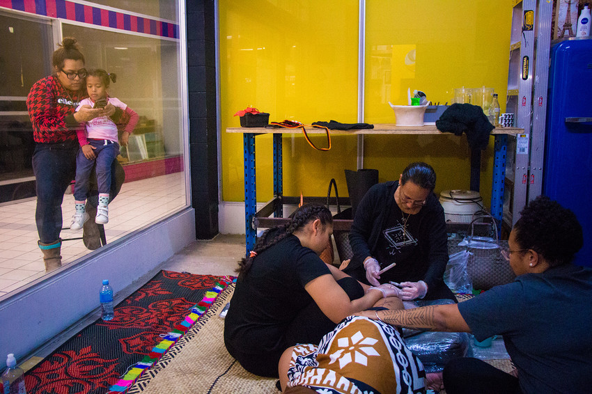 Melanesian hand poke & hand tap tatu artist Julia Mage’au Gray doing live tattooing in the space during the opening weekend