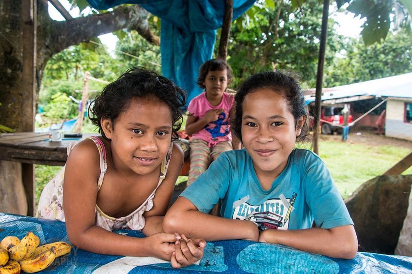 Kids selling their fruit on the side of the road