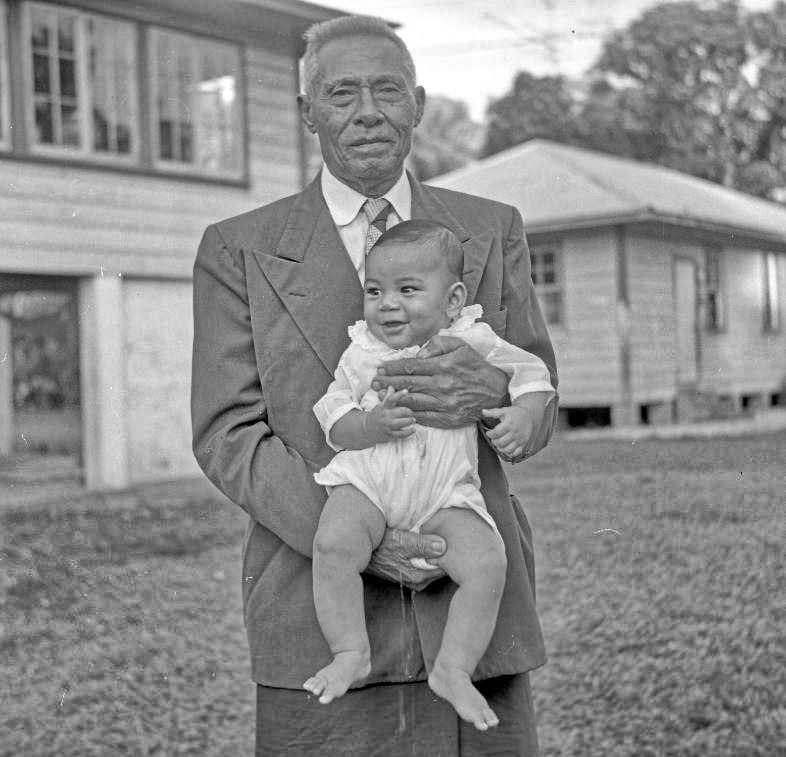 I'iga Pisa with baby outside their family home in Apia, 1957