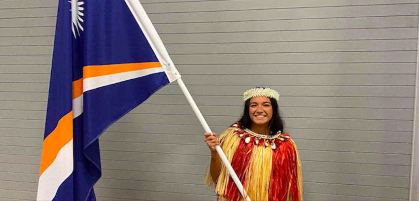Colleen holding the Marshall Island's flag for the Opening Ceremony of the Tokyo Olympics