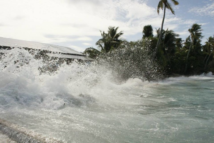 Waves crashing into a house in Tokelau