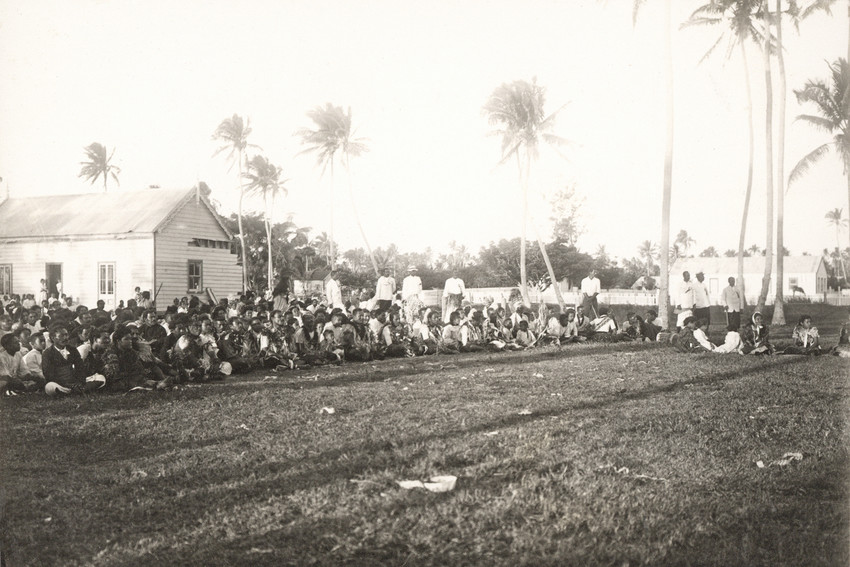 Spectators and performers watch the dances.