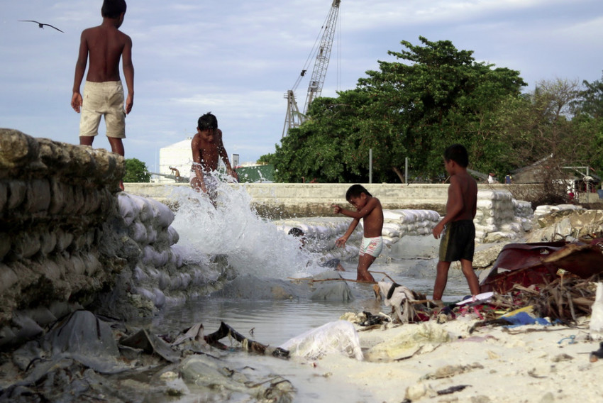 King Tide waves hitting through a seawall in Kiribati