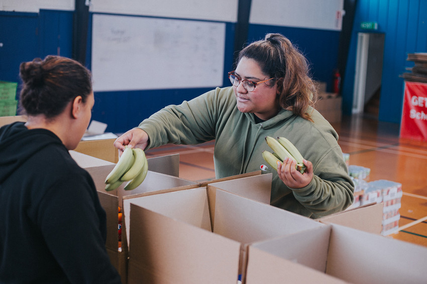 Volunteers help pack food parcels