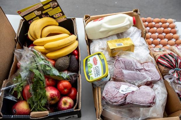 Food parcel ready for collection includes fresh veges and fruit, milk, butter, eggs, bread and meat. Photo / Michael Craig for NZ Herald