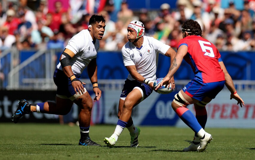 Christian Leali'ifano of Samoa runs with the ball whilst under pressure from Santiago Pedrero of Chile during the Rugby World Cup France 2023 match between Samoa and Chile at Nouveau Stade de Bordeaux on September 16, 2023 in Bordeaux, France. (Photo
