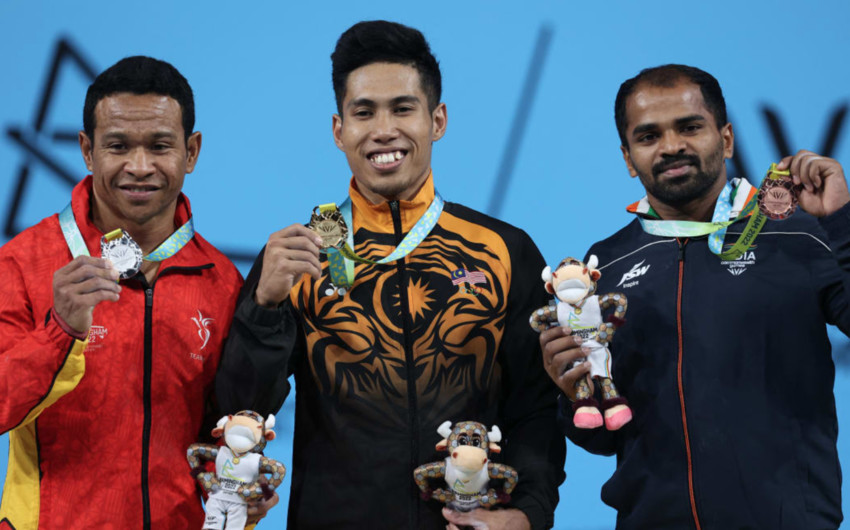 Gold medallist Malaysia's Aznil Bin Bidin Muhamad (centre), silver medallist Papua New Guinea's Morea Baru and bronze medallist India's Gururaja Gururaja. Photo: DARREN STAPLES