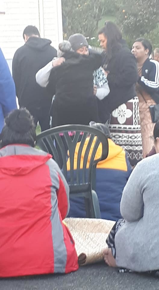 Family members of a woman who handed herself in to police after she killed her partner in Sydney Australia, embrace the victims mother during an ifoga in New Zealand. Photo Credit: LewisRachel Tuiepa